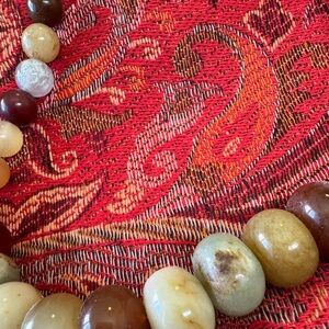 About 9” long with beautiful natural stone beads .